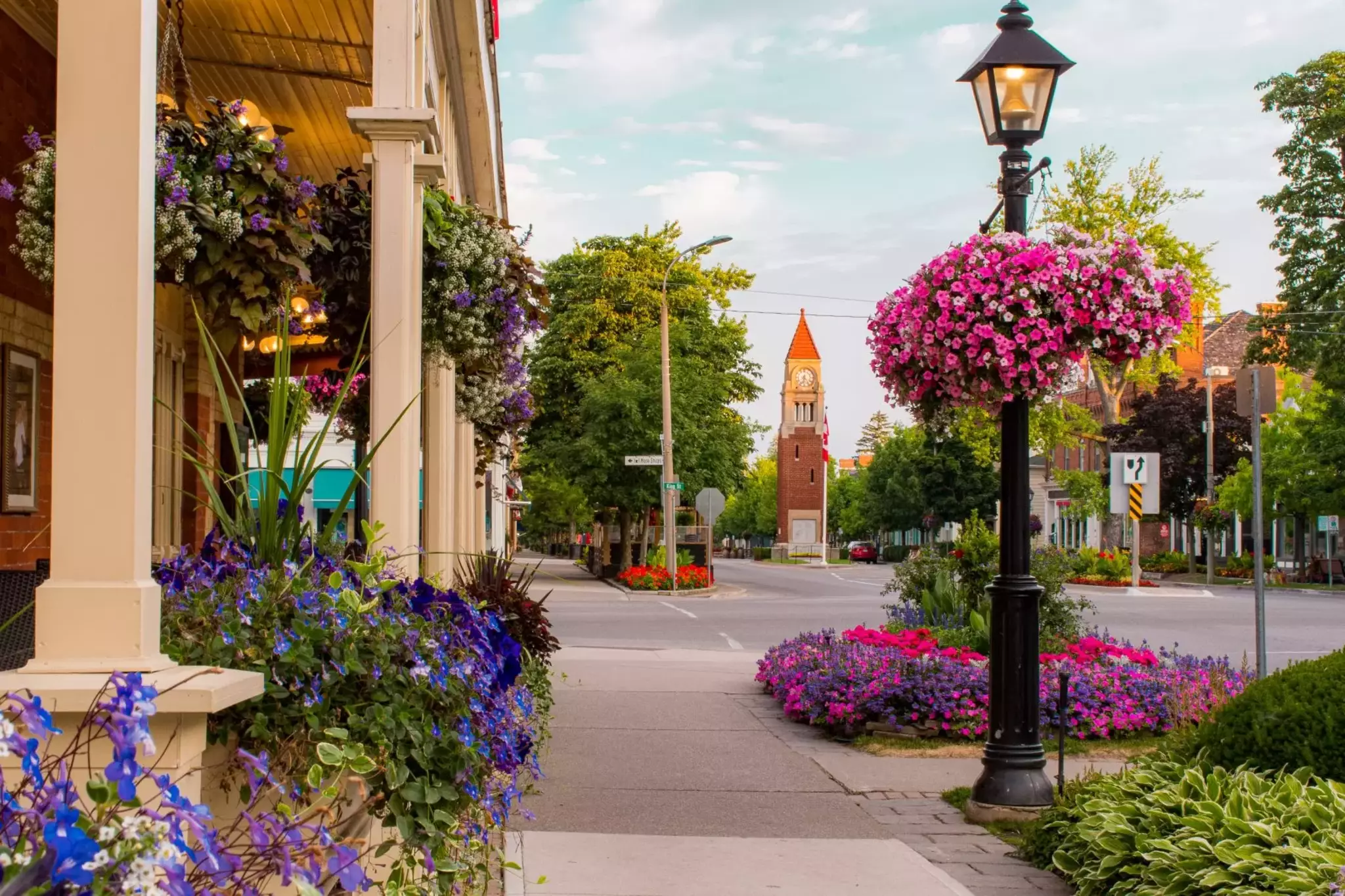 Hanging flower baskets along Queen Street in Niagara-on-the-Lake, with the clock tower in the background